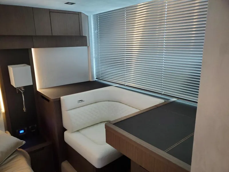 Slide: The Image of Interior of 2020 Galeon 500 Fly yacht with modern seating and blinds. - 18
