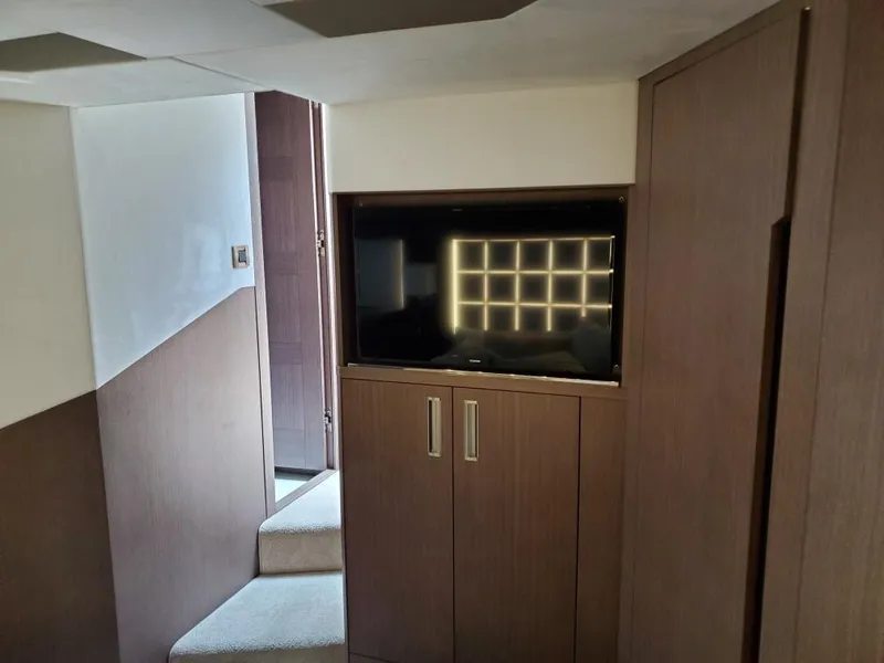 Slide: The Image of Interior of 2020 Galeon 500 Fly yacht with TV and wooden cabinetry. - 20