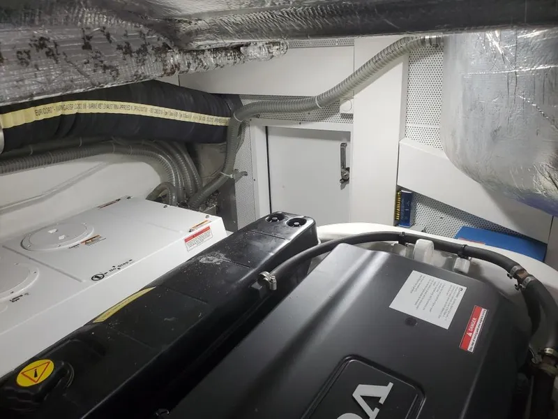 Slide: The Image of Engine room of a 2020 Galeon 500 Fly yacht with visible machinery and wiring. - 27