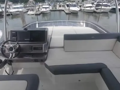 Slide: The Image of Flybridge of 2020 Galeon 500 Fly yacht with marina in background. - 30