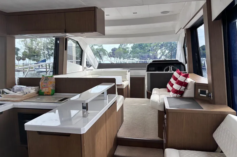 Slide: The Image of Interior of 2020 Galeon 500 Fly yacht with modern kitchen and seating area. - 32