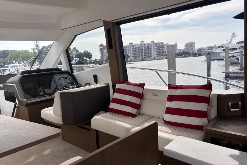 Slide: The Image of Interior of 2020 Galeon 500 Fly yacht with striped cushions and waterfront view. - 34