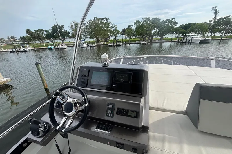 Slide: The Image of Galeon 500 Fly 2020 yacht helm with steering wheel and control panel, docked in a marina. - 37