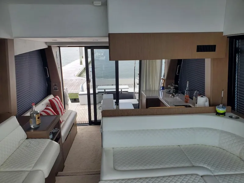 Slide: The Image of Interior of 2020 Galeon 500 Fly yacht with modern white seating and kitchenette. - 8