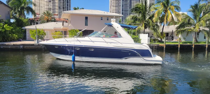 Slide: The Image of 2006 Formula 34 PC yacht cruising near waterfront homes and palm trees. - 11