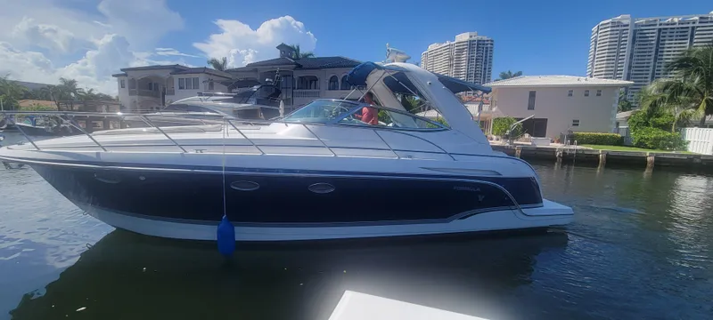 Slide: The Image of 2006 Formula 34 PC yacht docked in a sunny marina setting. - 14