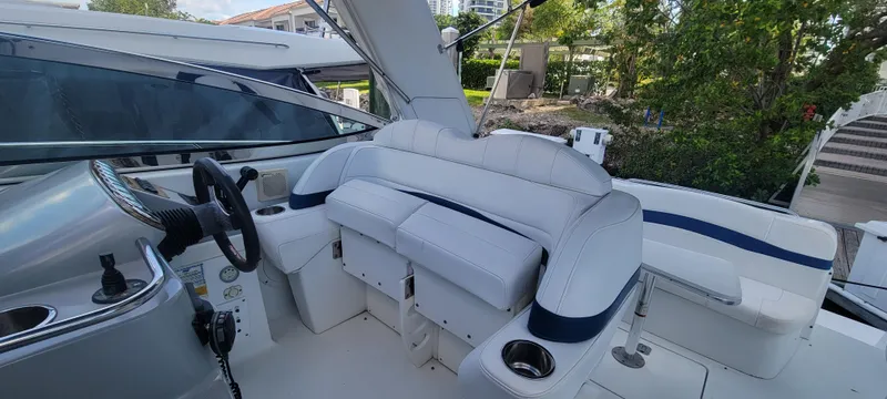 Slide: The Image of 2006 Formula 34 PC boat cockpit with white seating and steering wheel. - 24