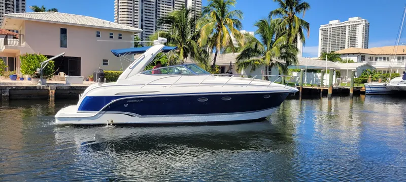 Slide: The Image of 2006 Formula 34 PC yacht docked in a sunny waterfront setting. - 6
