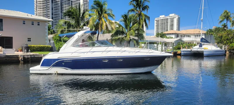 Slide: The Image of 2006 Formula 34 PC yacht docked in sunny marina with palm trees and buildings. - 7