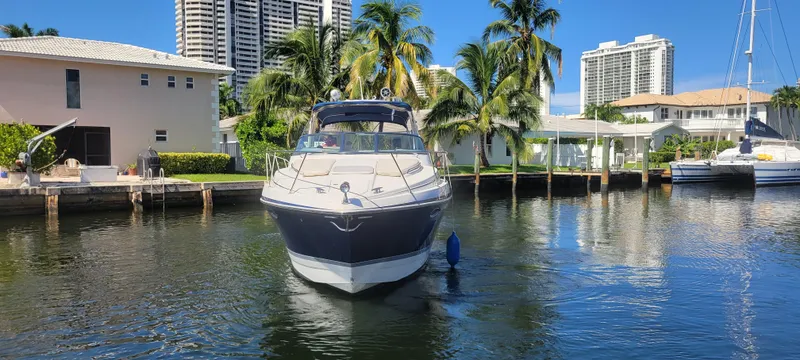 Slide: The Image of 2006 Formula 34 PC yacht docked in a sunny, tropical canal setting. - 9
