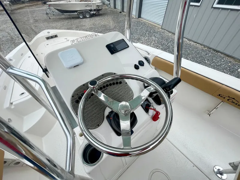 Slide: The Image of 2024 Sea Chaser 21 LX boat console with steering wheel and controls. - 5