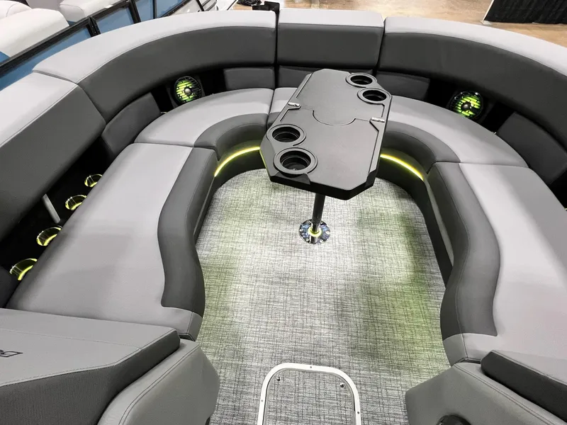 Slide: The Image of 2024 Berkshire 25ULE Roswell Arch STS Tritoon interior with gray seating and central table. - 10