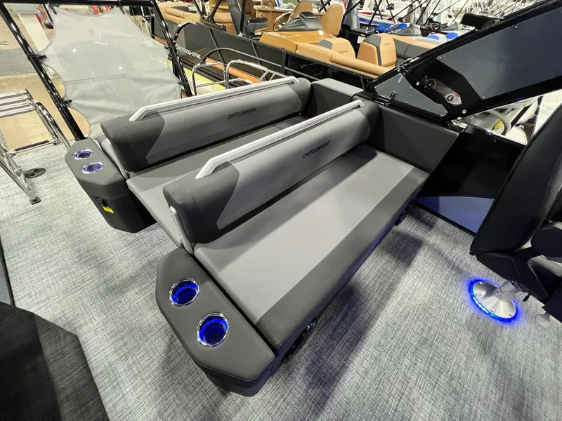Slide: The Image of 2024 Berkshire 25ULE Roswell Arch STS Tritoon interior with gray seating and illuminated cup holders. - 12