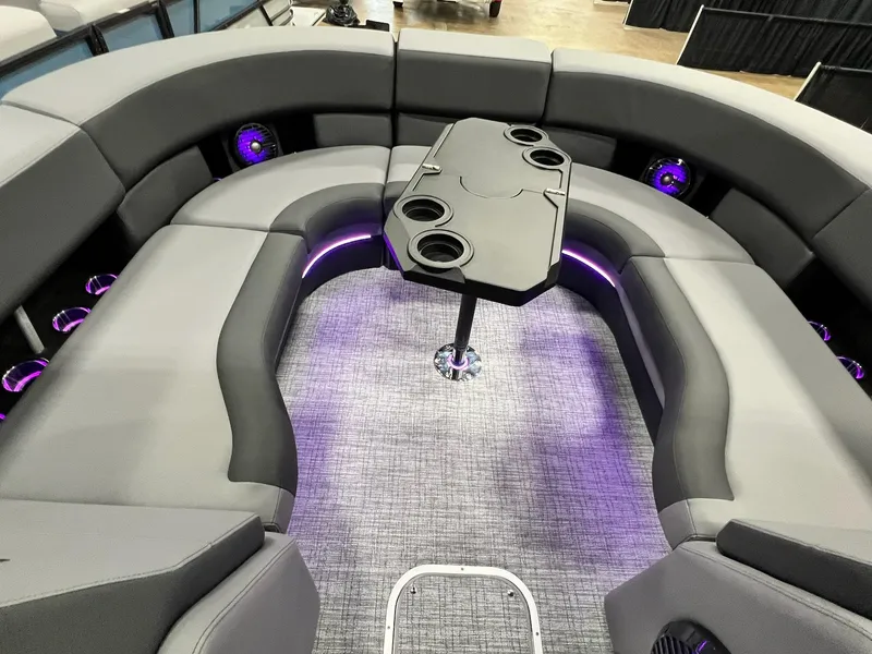 Slide: The Image of 2024 Berkshire 25ULE Roswell Arch STS Tritoon interior with plush seating and ambient lighting. - 15
