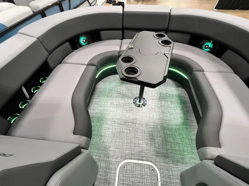 Slide: The Image of 2024 Berkshire 25ULE Roswell Arch STS Tritoon interior with gray seating and central table. - 23