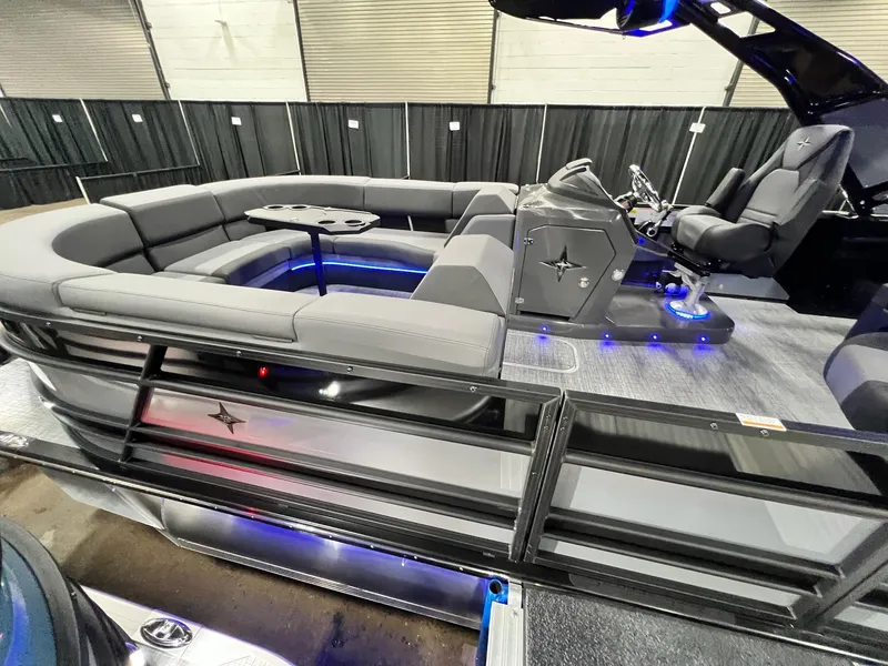 Slide: The Image of 2024 Berkshire 25ULE Roswell Arch STS Tritoon with sleek seating and modern helm design. - 26