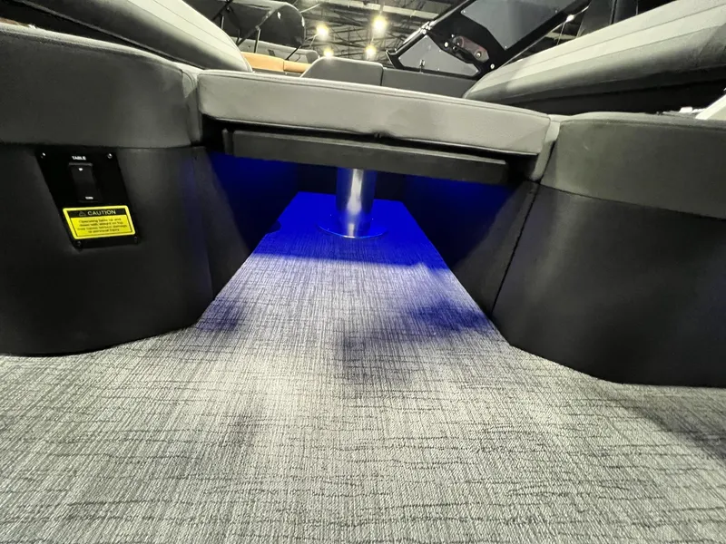 Slide: The Image of 2024 Berkshire 25ULE Roswell Arch STS Tritoon interior with blue LED lighting and gray flooring. - 30
