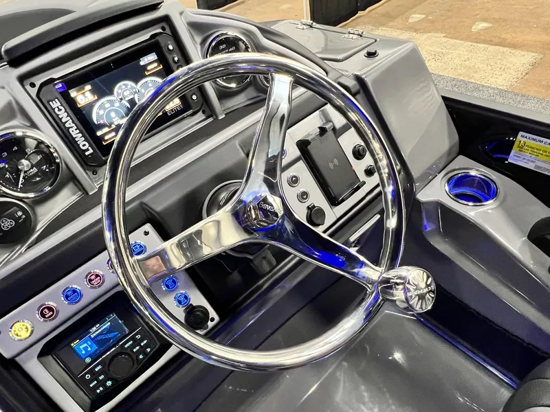 Slide: The Image of Steering console of 2024 Berkshire 25ULE Roswell Arch STS Tritoon with modern controls and displays. - 32