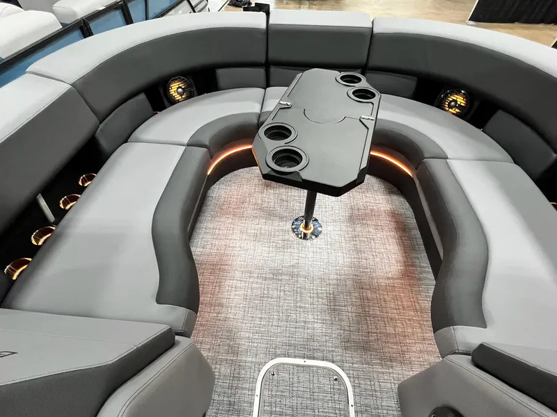 Slide: The Image of Interior of 2024 Berkshire 25ULE Roswell Arch STS Tritoon with grey seating and table. - 39