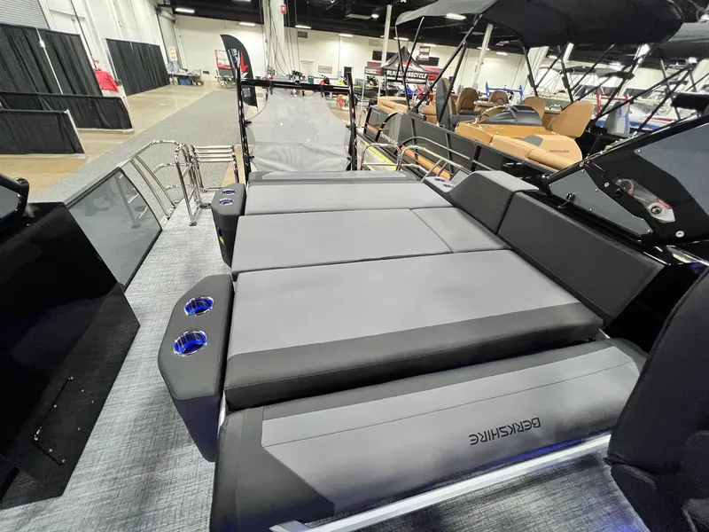 Slide: The Image of 2024 Berkshire 25ULE Roswell Arch STS Tritoon interior with gray seating and cup holders. - 48