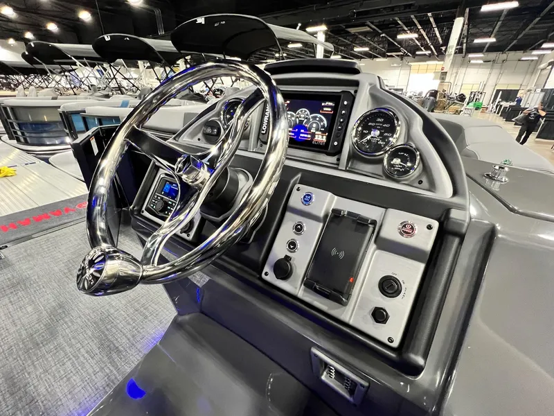 Slide: The Image of 2024 Berkshire 25ULE Roswell Arch STS Tritoon dashboard with modern controls and steering wheel. - 50