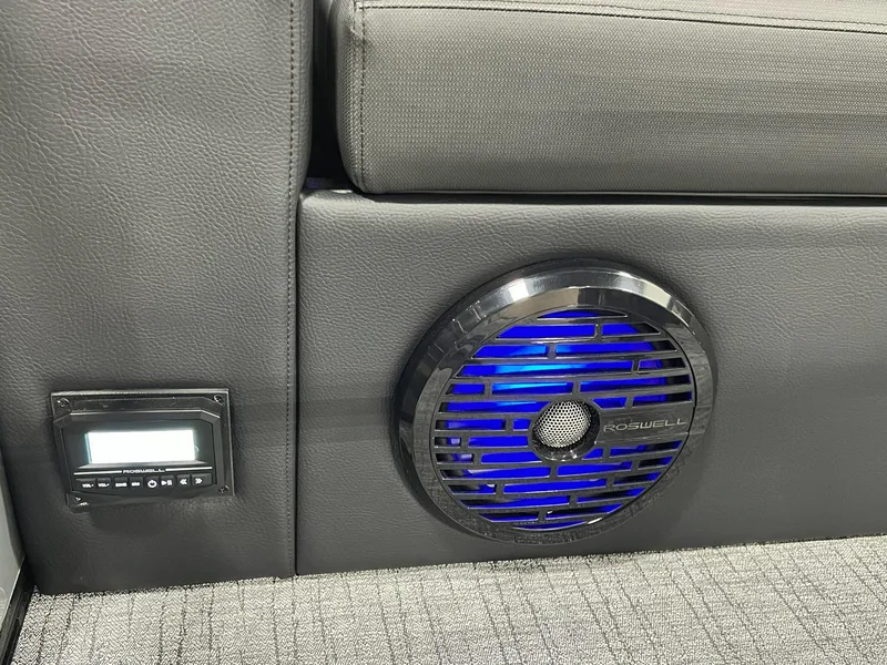 Slide: The Image of 2024 Berkshire 25ULE Roswell Arch STS Tritoon interior with illuminated speaker and control panel. - 7