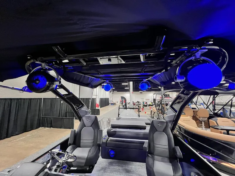 Slide: The Image of 2024 Berkshire 25ULE Roswell Arch STS Tritoon interior with blue LED lighting and sleek seating. - 8