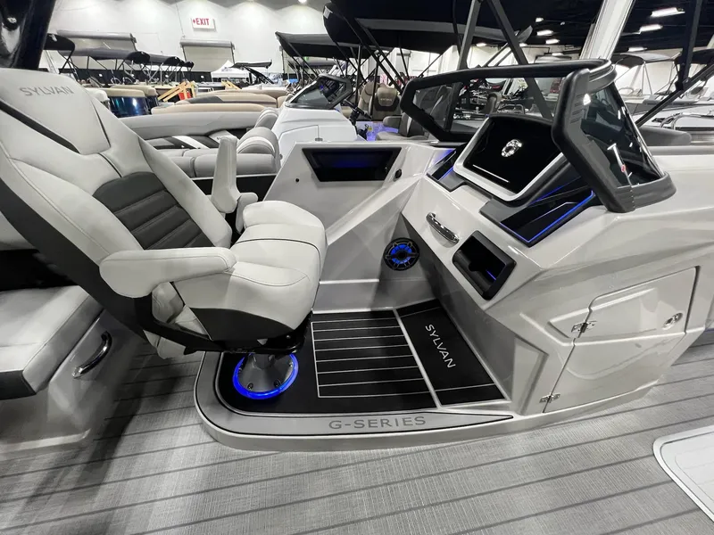 Slide: The Image of 2024 Sylvan G5 CLZ DC Arch Tritoon interior with modern helm and luxurious seating. - 10