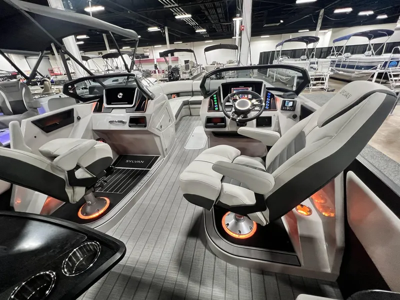 Slide: The Image of 2024 Sylvan G5 CLZ DC Arch Tritoon interior with modern helm and luxurious seating. - 14