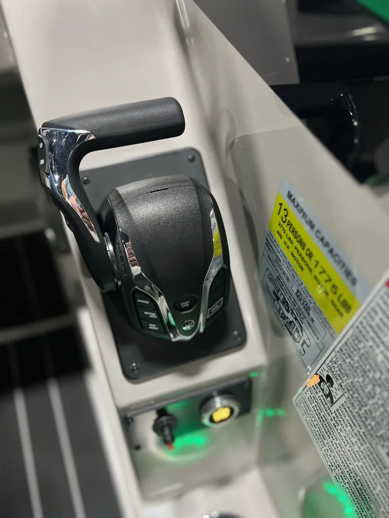 Slide: The Image of Close-up of 2024 Sylvan G5 CLZ DC Arch Tritoon throttle control and capacity label. - 17