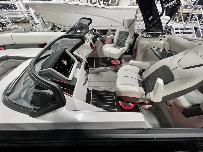 Slide: The Image of 2024 Sylvan G5 CLZ DC Arch Tritoon interior with modern seating and dashboard. - 18