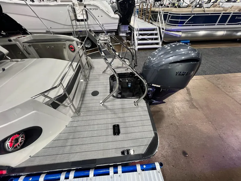 Slide: The Image of 2024 Sylvan G5 CLZ DC Arch Tritoon with Yamaha outboard motor at a boat show. - 24