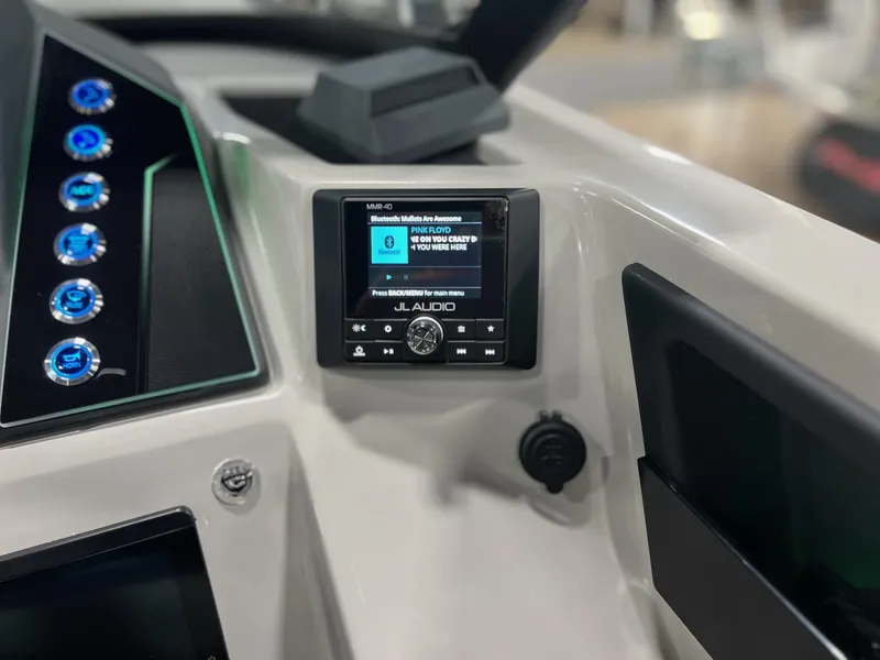 Slide: The Image of 2024 Sylvan G5 CLZ DC Arch Tritoon dashboard with JL Audio system and control panel. - 25