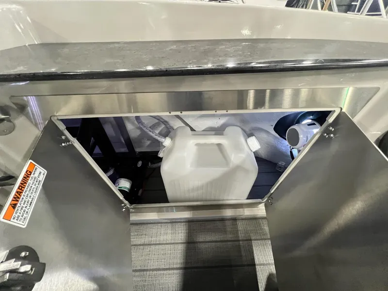 Slide: The Image of Storage compartment in 2024 Sylvan G5 CLZ DC Arch Tritoon, featuring a white container. - 27