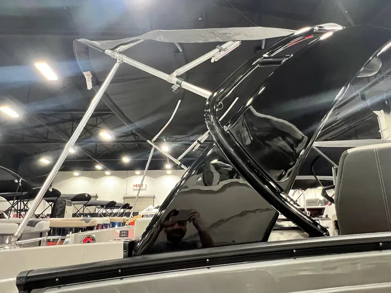 Slide: The Image of 2024 Sylvan G5 CLZ DC Arch Tritoon boat interior with black arch and canopy. - 29