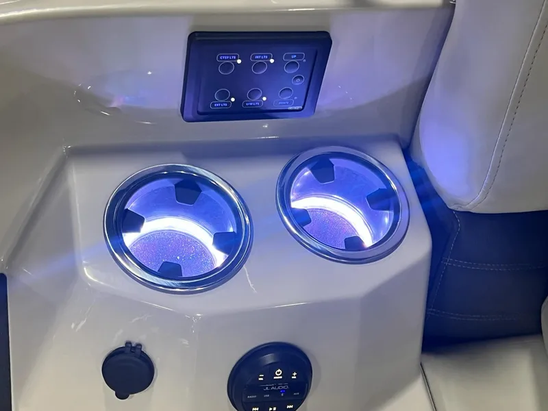 Slide: The Image of Illuminated cup holders and control panel on 2024 Sylvan G5 CLZ DC Arch Tritoon. - 4