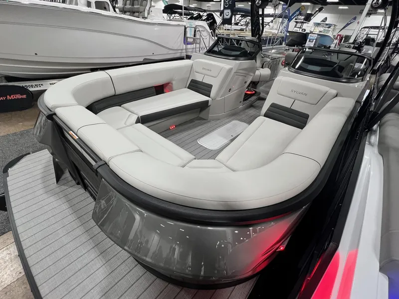 Slide: The Image of 2024 Sylvan G5 CLZ DC Arch Tritoon with luxurious seating at a boat show. - 48