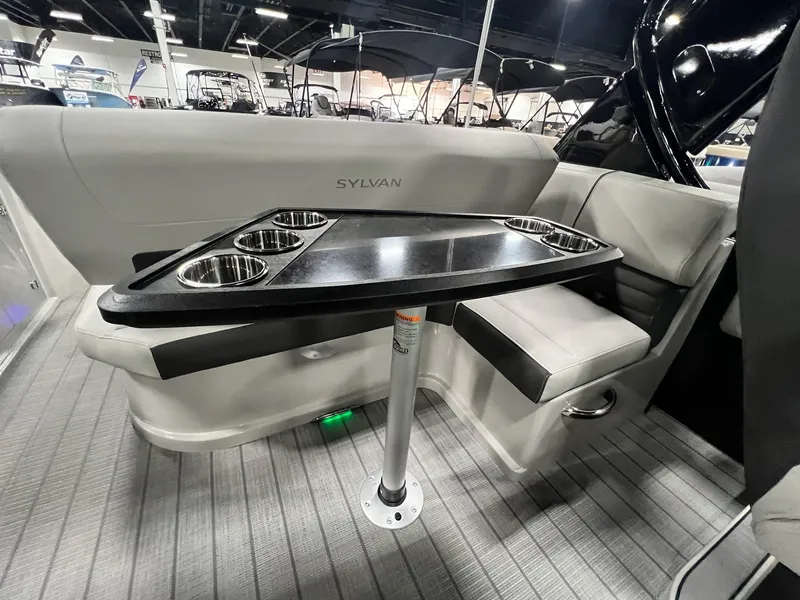 Slide: The Image of Interior seating and table of 2024 Sylvan G5 CLZ DC Arch Tritoon boat. - 5