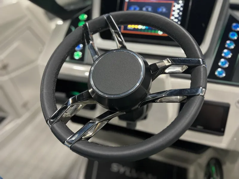 Slide: The Image of Close-up of the steering wheel and dashboard of a 2024 Sylvan G5 CLZ DC Arch Tritoon. - 8