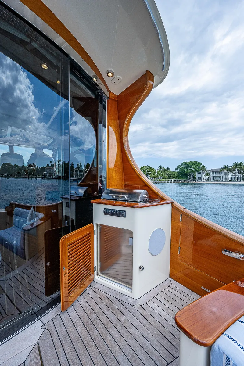 Slide: The Image of 2018 Hinckley Talaria 55 MKII MY yacht deck with sleek wood finish and scenic water view. - 12