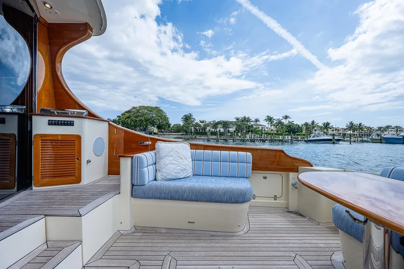 Slide: The Image of Luxurious 2018 Hinckley Talaria 55 MKII MY yacht deck with elegant seating and scenic water view. - 15