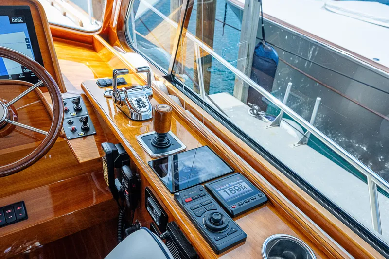 Slide: The Image of 2018 Hinckley Talaria 55 MKII MY helm with wooden dashboard and modern controls. - 29