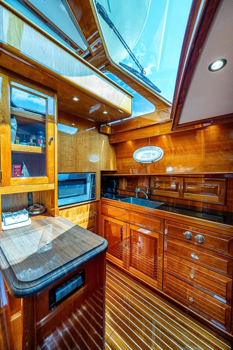 Slide: The Image of Luxurious 2018 Hinckley Talaria 55 MKII MY yacht interior with elegant wood finish and modern amenities. - 35