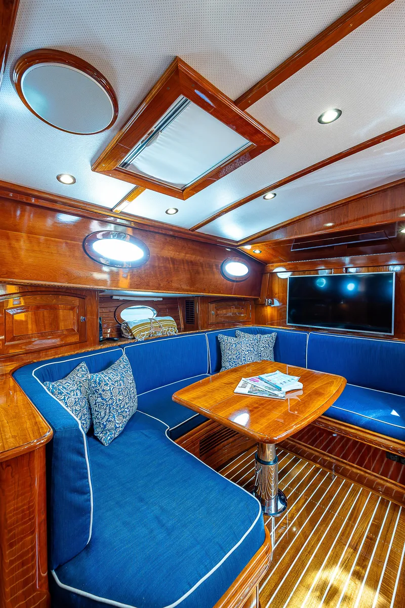 Slide: The Image of Luxurious 2018 Hinckley Talaria 55 MKII MY yacht interior with elegant wood and blue seating. - 40