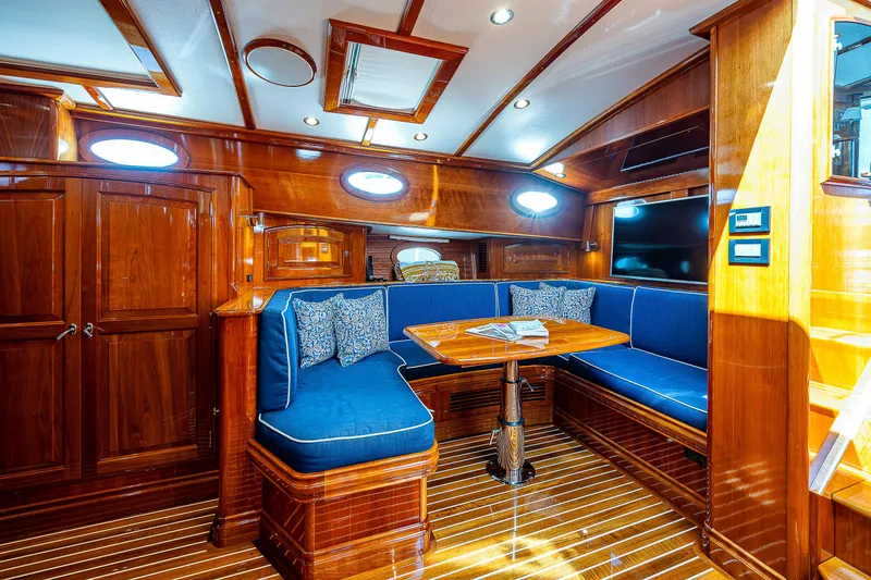 Slide: The Image of Luxurious 2018 Hinckley Talaria 55 MKII MY yacht interior with elegant wood finish and blue seating. - 42
