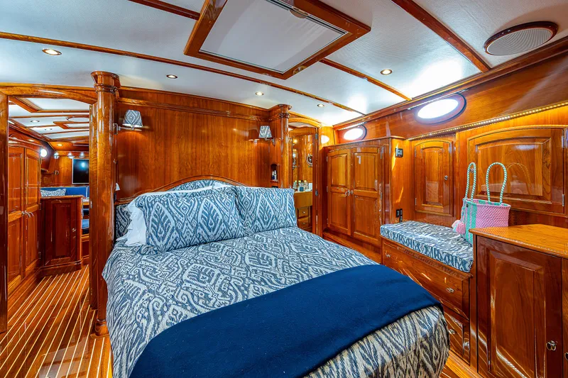 Slide: The Image of Luxurious 2018 Hinckley Talaria 55 MKII MY yacht cabin with elegant wood finish and cozy bedding. - 49