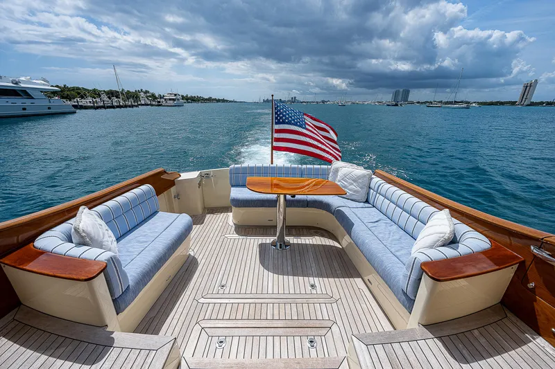 Slide: The Image of 2018 Hinckley Talaria 55 MKII MY yacht with elegant seating and American flag on open water. - 6