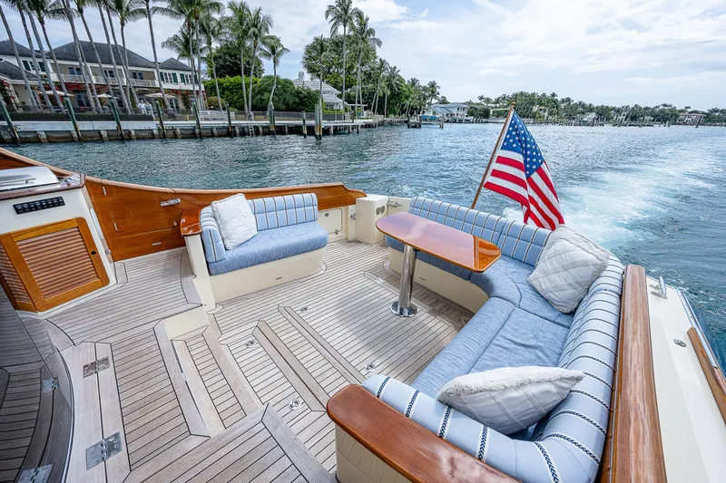 Slide: The Image of Hinckley Talaria 55 MKII MY 2018 yacht deck with seating, table, and American flag. - 7