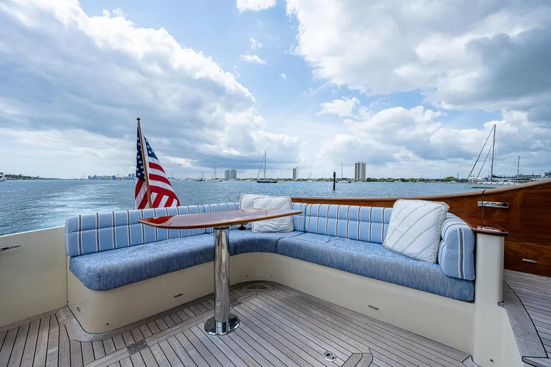 Slide: The Image of 2018 Hinckley Talaria 55 MKII MY yacht deck with seating, table, and American flag. - 8
