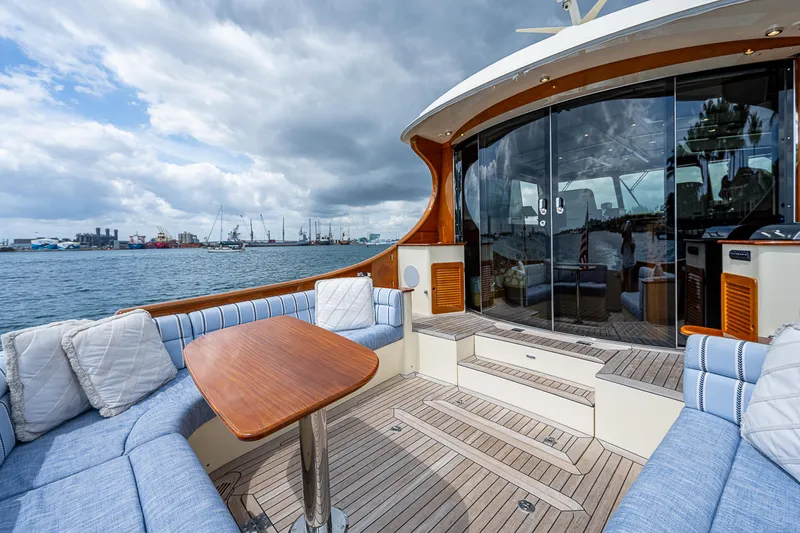 Slide: The Image of Luxurious 2018 Hinckley Talaria 55 MKII MY yacht with elegant seating and scenic ocean view. - 9